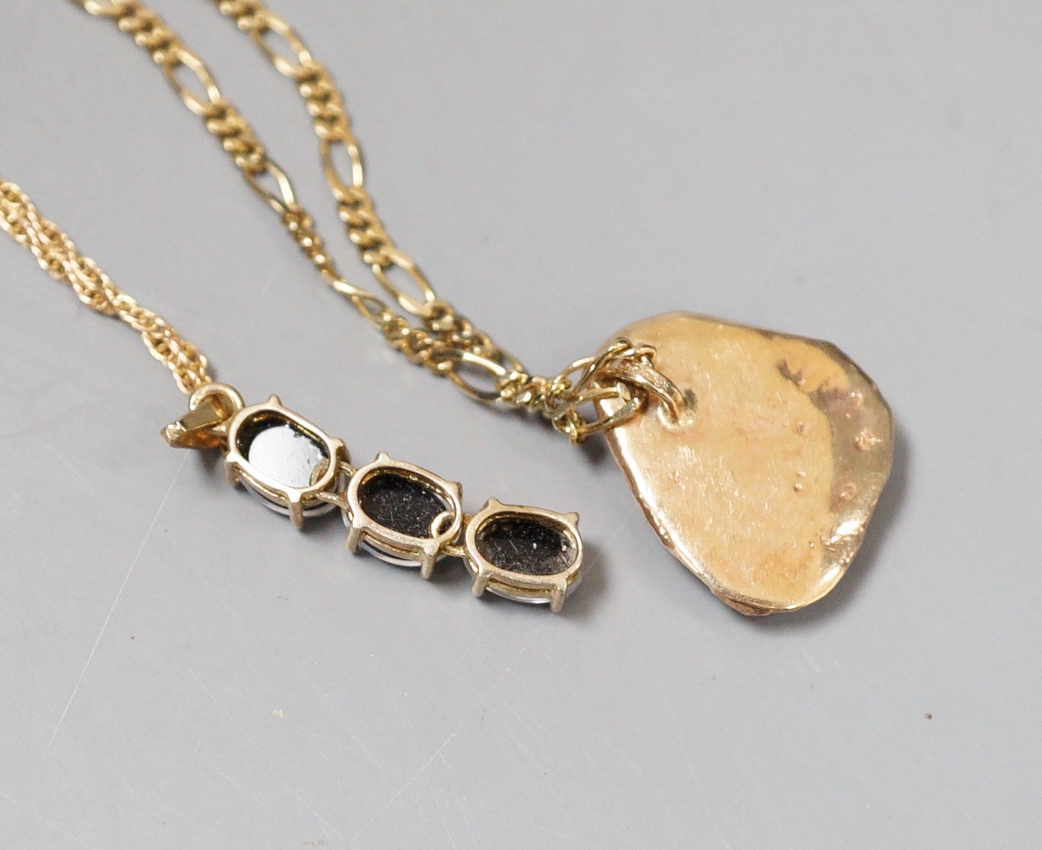 Two modern 9ct and opal set pendants, on 9ct gold chains, gross weight 10.6 grams.